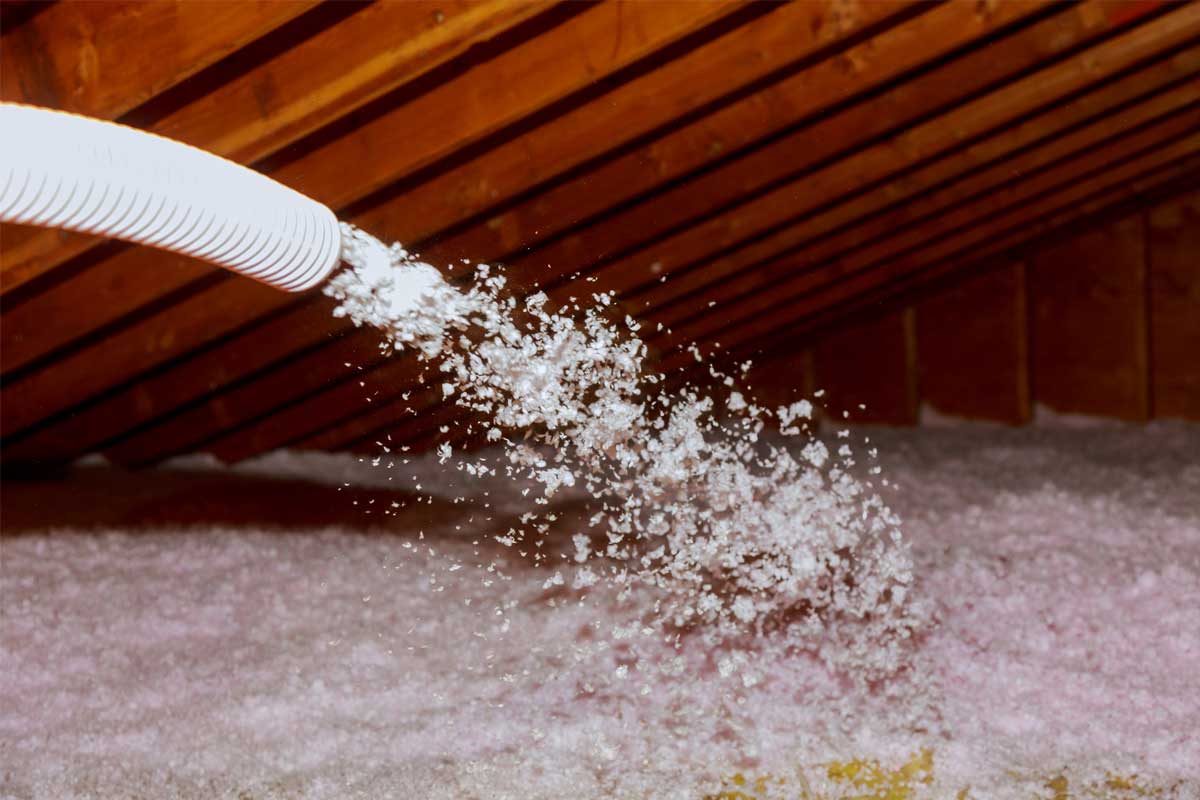 Blown-in cellulose insulation installation in attic, Michigan Smart Energy service.