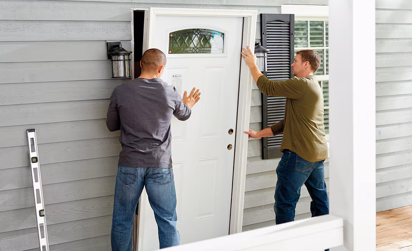 Exterior door replacement installation by Michigan Smart Energy crew, insulated and sealed for energy efficiency.