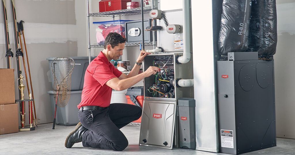 Technician installing a new furnace for energy-efficient water heater replacement.