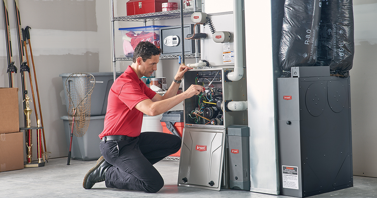 Technician installing a high-efficiency Bryant furnace in a Michigan home.