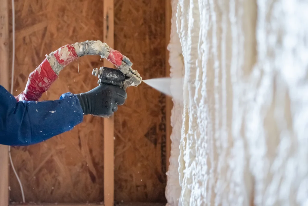 Injection wall foam being applied to wall cavity, filling gaps and stopping drafts in Michigan homes.