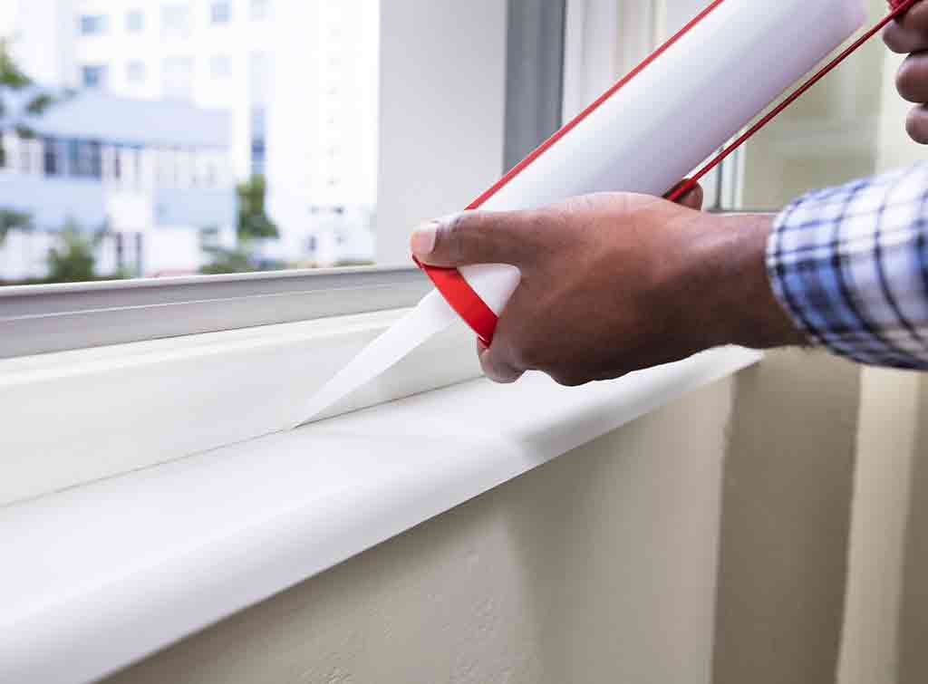 Weatherstripping and caulking sealing window gaps for air sealing services.
