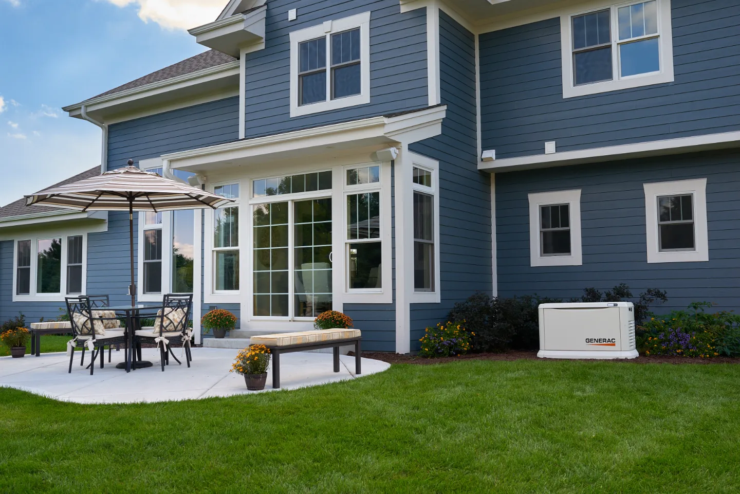 Blue Michigan home with upgraded insulation and a Generac generator for energy efficiency.